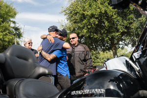 U.S. Marine veteran Raymond Andalio and U.S. Army veteran Brian Torres embrace after learning they both would receive brand-new 2015 Harley-Davidson motorcycles. The surprise delivery jumpstarted a new partnership between Harley-Davidson and Wounded Warrior Project to help improve the lives of service men and women living with post-traumatic stress disorder (PTSD).